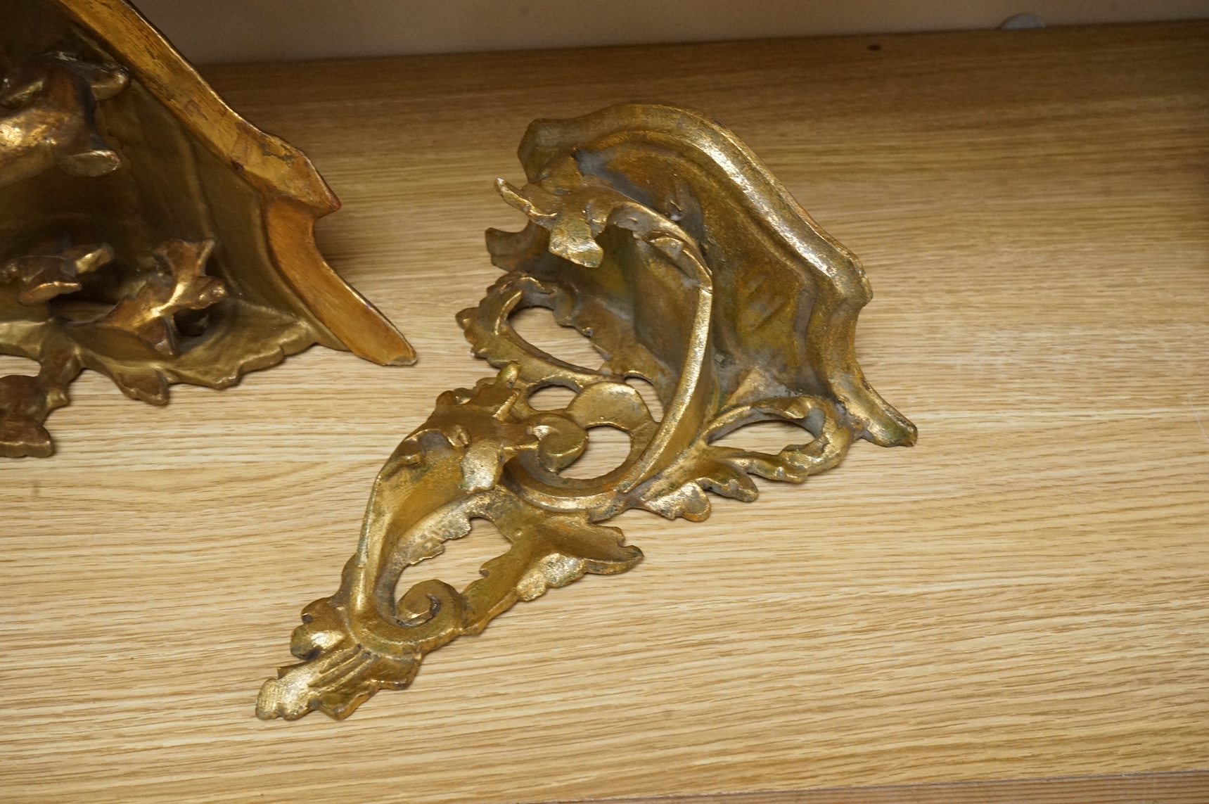 A large giltwood wall bracket- 28cm high together with a smaller similar wall bracket.
